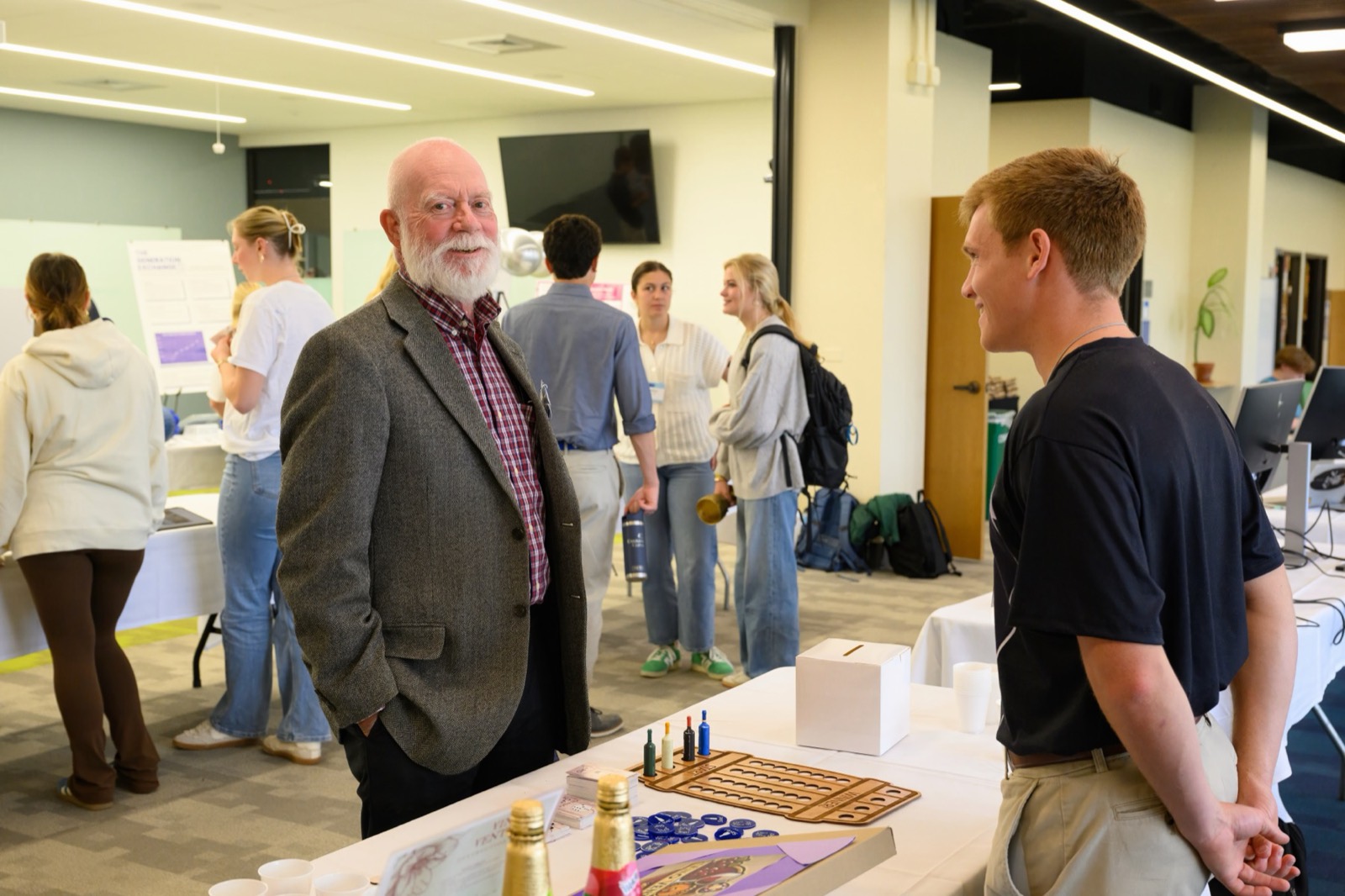 An alumnus talking with a student founder at the Summit