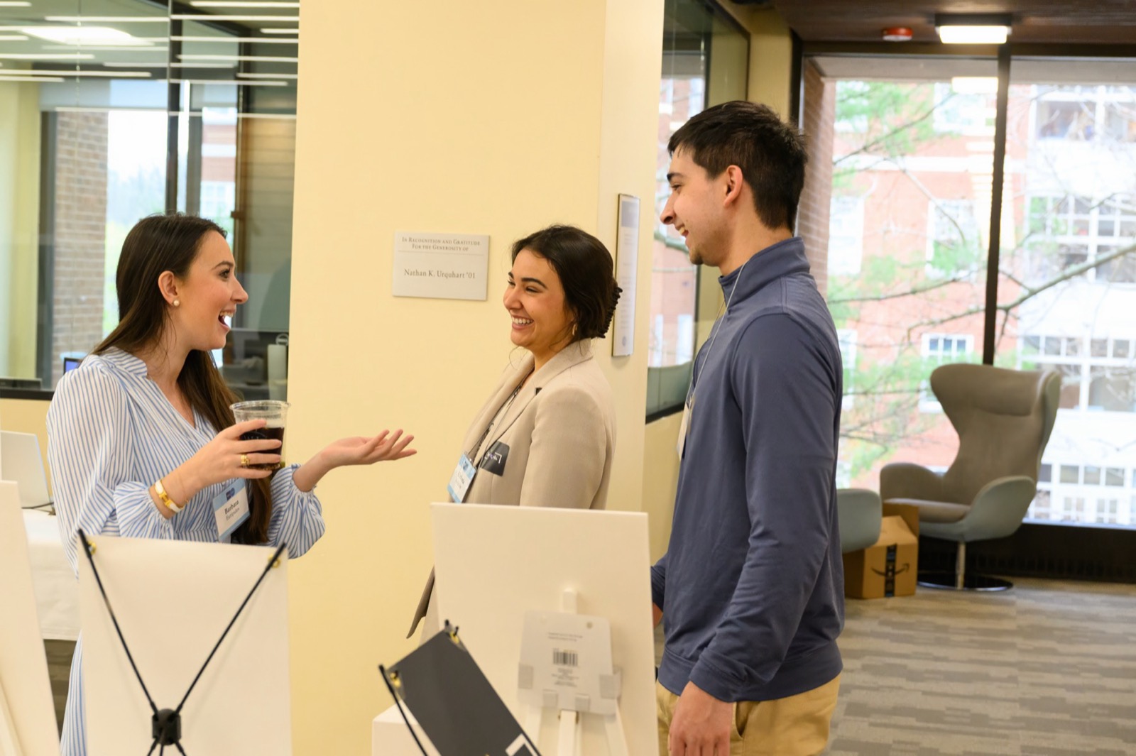 Students talking with a visitor at their venture's table